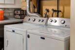 This laundry room features a Maytag washer and dryer set, perfect for handling all your laundry needs.