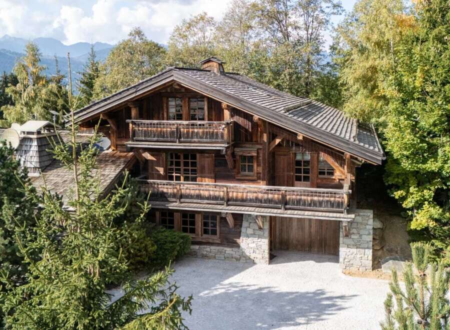 Experience the charm of this rustic wooden chalet nestled amidst lush greenery and majestic mountains.