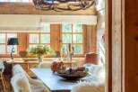 Experience rustic elegance in this charming dining room, featuring a magnificent antler chandelier that casts a warm glow.