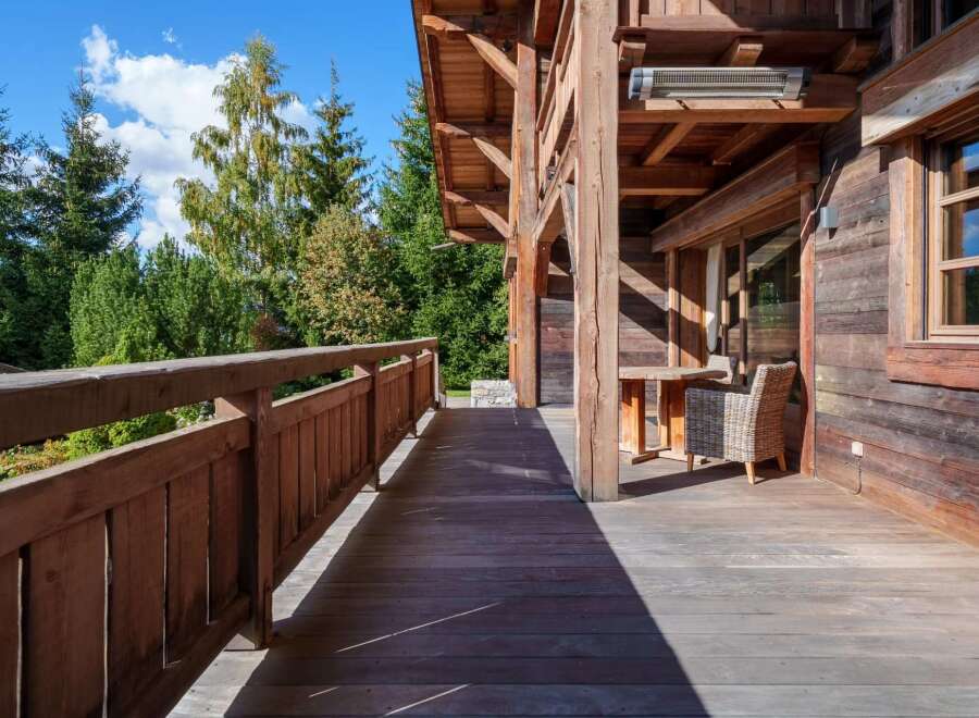 Enjoy the serene mountain views from this expansive wooden deck, perfect for outdoor relaxation and entertaining.