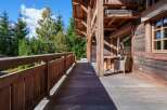 Enjoy the serene mountain views from this expansive wooden deck, perfect for outdoor relaxation and entertaining.