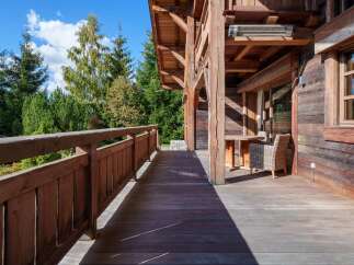 Enjoy the serene mountain views from this expansive wooden deck, perfect for outdoor relaxation and entertaining.