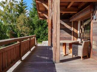 Experience the charm of this rustic wooden cabin, featuring a spacious deck perfect for enjoying the surrounding nature.