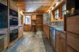 Experience rustic charm in this beautifully appointed wooden kitchen, featuring modern Miele appliances including a built-in oven and microwave.