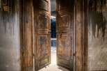 Step through these magnificent, antique wooden double doors, showcasing intricate carvings and a distressed finish that adds character and history.