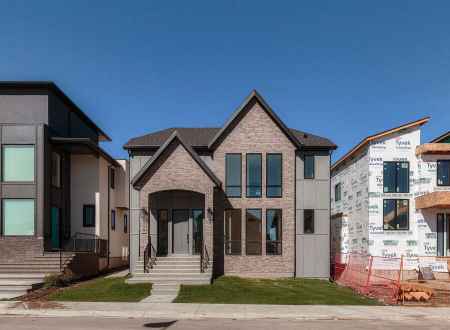 Discover modern luxury in this stunning new construction home, featuring a striking architectural design with a blend of brick and contemporary siding.