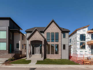 Discover modern luxury in this stunning new construction home, featuring a striking architectural design with a blend of brick and contemporary siding.