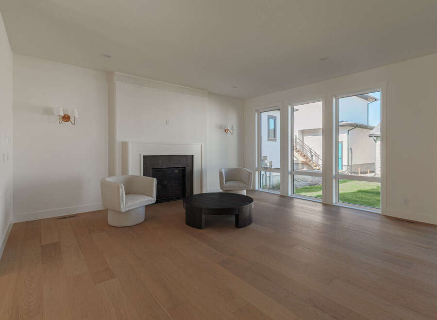Step into this bright and airy living room, featuring a modern fireplace as the focal point.