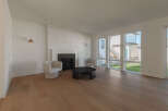 Step into this bright and airy living room, featuring a modern fireplace as the focal point.