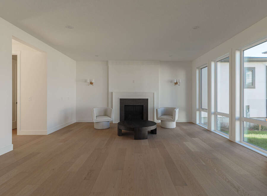 Step into this bright and airy living room, featuring a modern fireplace as the focal point.