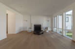 Step into this bright and airy living room, featuring a modern fireplace as the focal point.
