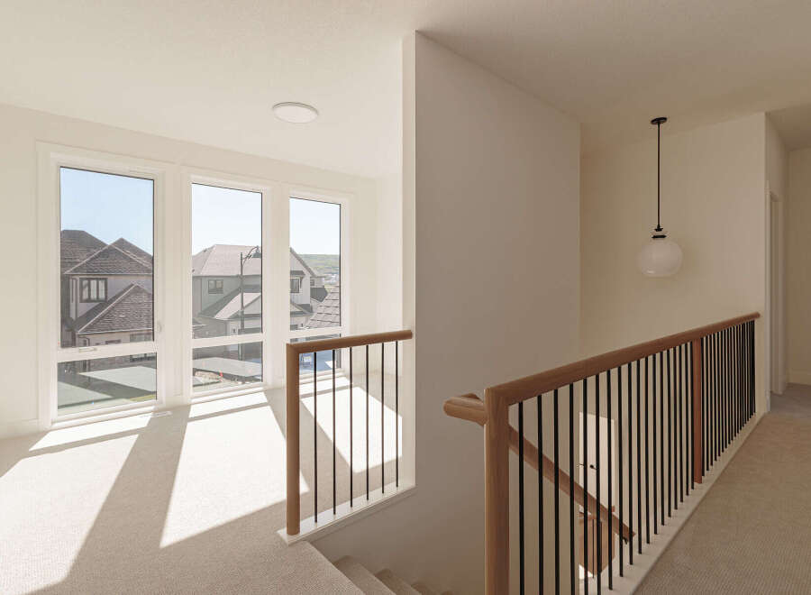 Step into this bright and airy hallway, bathed in natural light streaming through large windows.