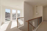 Step into this bright and airy hallway, bathed in natural light streaming through large windows.