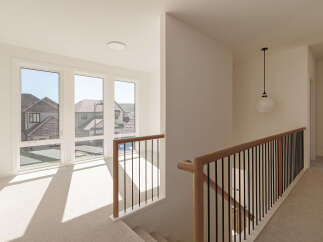 Step into this bright and airy hallway, bathed in natural light streaming through large windows.