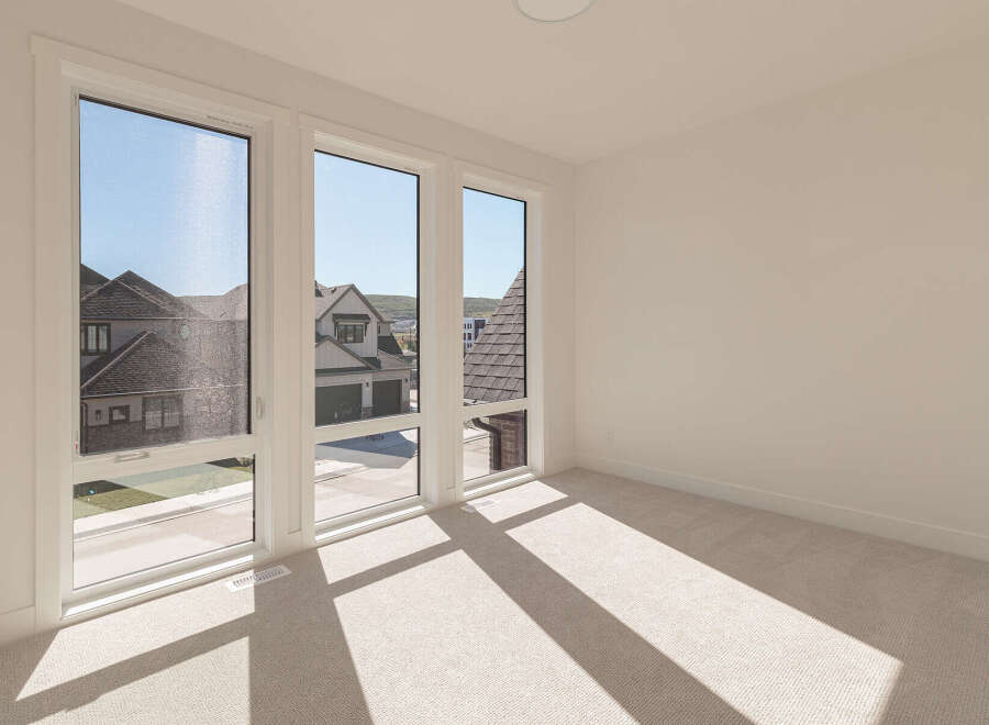Experience abundant natural light in this spacious room, featuring large, modern windows that offer picturesque views of the neighborhood.