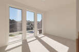 Experience abundant natural light in this spacious room, featuring large, modern windows that offer picturesque views of the neighborhood.