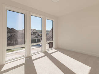 Experience abundant natural light in this spacious room, featuring large, modern windows that offer picturesque views of the neighborhood.