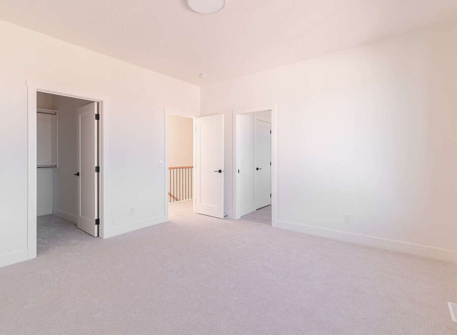 Step into this bright and airy bedroom, featuring a spacious layout and plush carpeting for ultimate comfort.