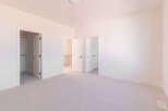 Step into this bright and airy bedroom, featuring a spacious layout and plush carpeting for ultimate comfort.