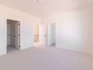 Step into this bright and airy bedroom, featuring a spacious layout and plush carpeting for ultimate comfort.