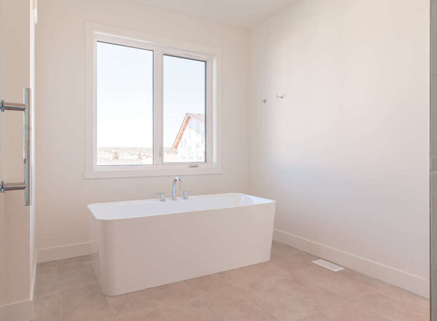 Experience luxury in this modern bathroom featuring a freestanding soaking tub, perfect for unwinding.