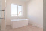 Experience luxury in this modern bathroom featuring a freestanding soaking tub, perfect for unwinding.