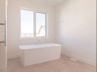 Experience luxury in this modern bathroom featuring a freestanding soaking tub, perfect for unwinding.
