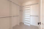 Step into this spacious walk-in closet, designed for ultimate organization and style.