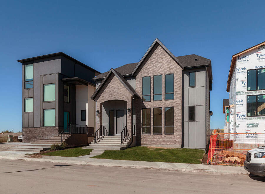 Experience modern luxury in this stunning new construction home, featuring a striking architectural design with a blend of brick and contemporary siding.