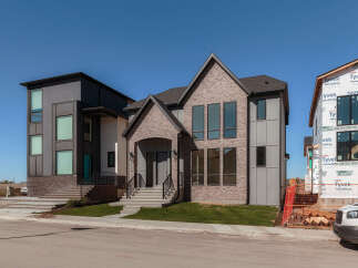 Experience modern luxury in this stunning new construction home, featuring a striking architectural design with a blend of brick and contemporary siding.