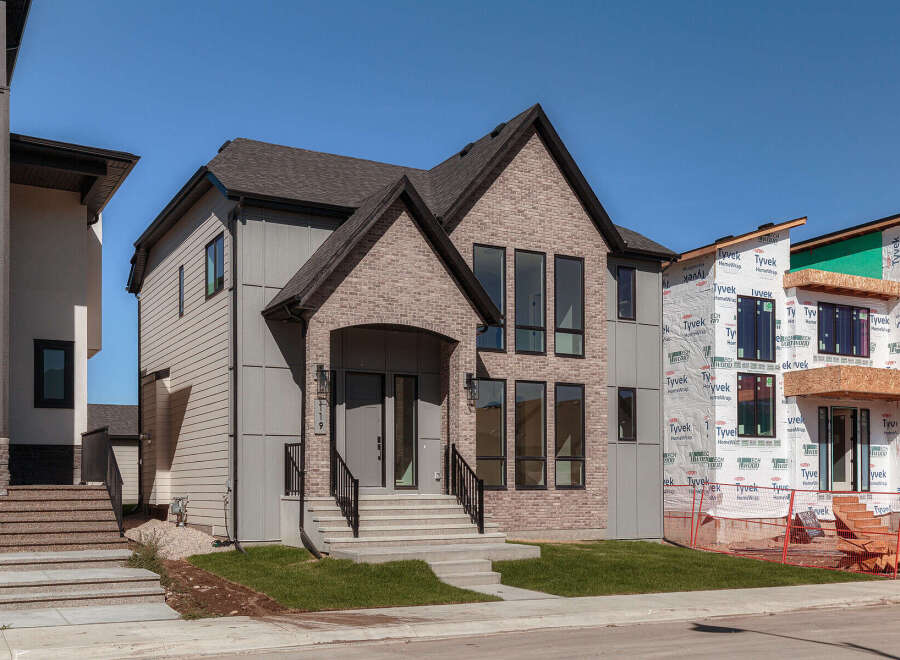 Discover modern living in this stunning new construction home, featuring a striking combination of light brick and sleek grey siding.