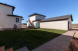 Discover modern living with this newly constructed property, featuring a sleek white exterior and a detached garage.
