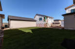 This property showcases a new construction home in its framing stages, wrapped in Tyvek for weather protection.