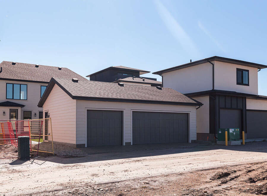 Discover modern living in this newly constructed home, featuring a spacious attached two-car garage and a separate single-car garage, perfect for vehicles or extra storage.