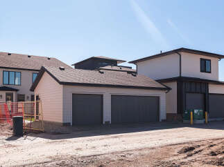 Discover modern living in this newly constructed home, featuring a spacious attached two-car garage and a separate single-car garage, perfect for vehicles or extra storage.