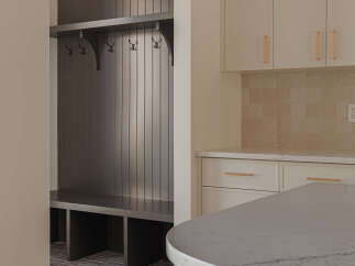 This modern home features a stylish mudroom with a dark wood built-in bench and coat rack, perfect for organization.
