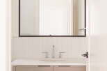 This modern bathroom features a sleek vanity with taupe cabinetry and a white quartz countertop.