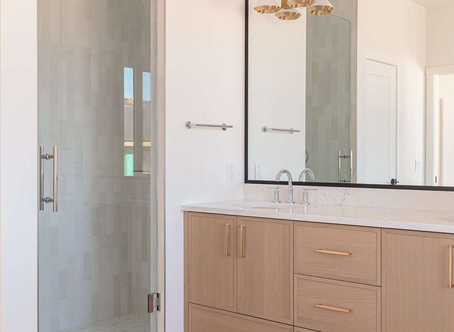 Experience modern luxury in this stunning bathroom featuring a sleek glass-enclosed shower with elegant tilework.