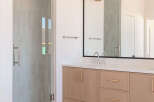 Experience modern luxury in this stunning bathroom featuring a sleek glass-enclosed shower with elegant tilework.
