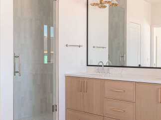 Experience modern luxury in this stunning bathroom featuring a sleek glass-enclosed shower with elegant tilework.