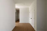Step into this beautifully appointed hallway, featuring pristine white walls and elegant white doors with modern black hardware.