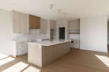 This modern kitchen boasts a spacious island with a built-in sink, perfect for meal preparation and casual dining.