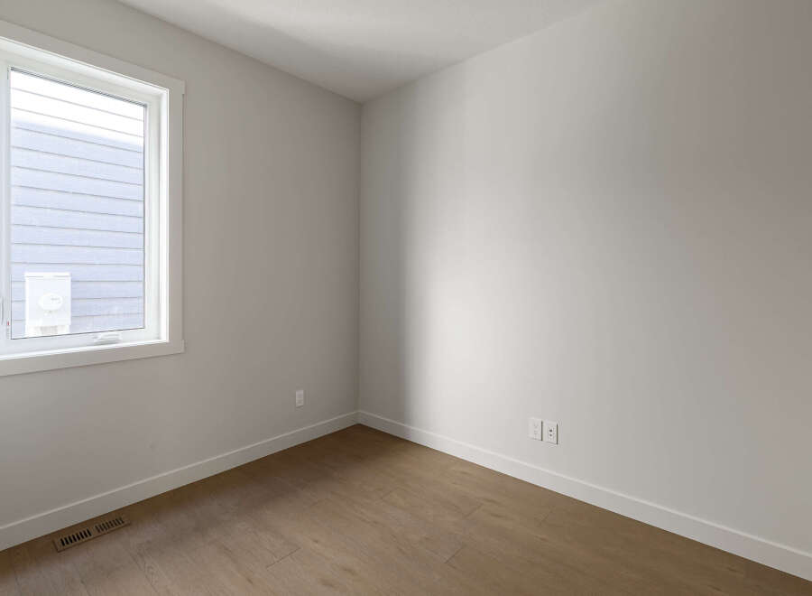 Step into this bright and airy room, featuring a large window that floods the space with natural light.
