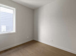 Step into this bright and airy room, featuring a large window that floods the space with natural light.