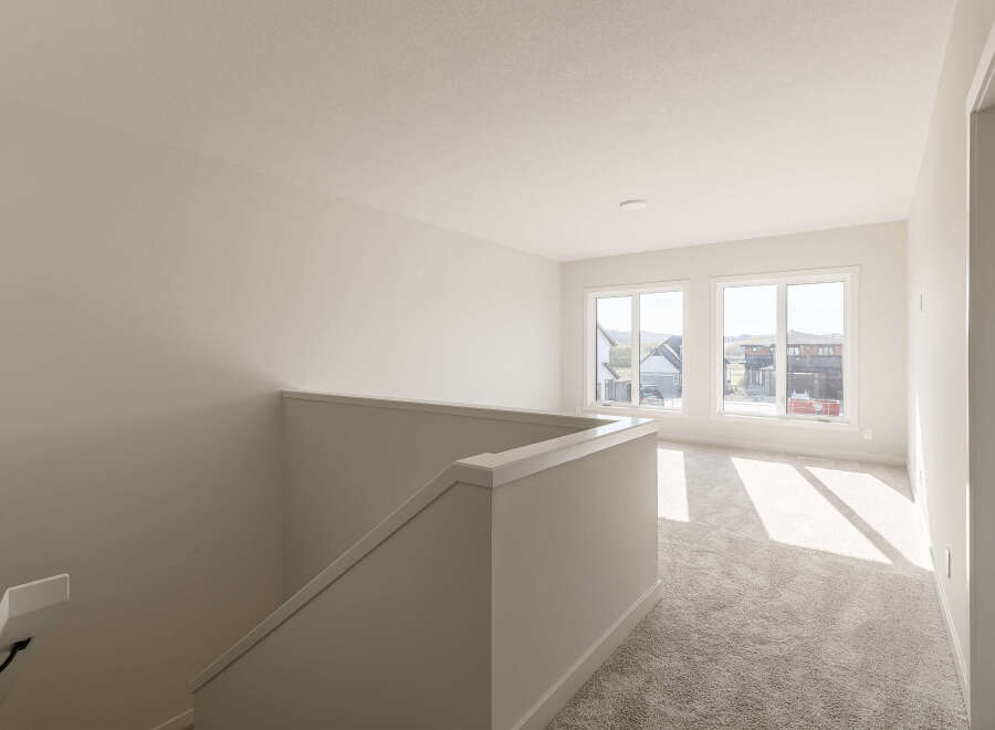 Step into this bright and airy upper-level living space, featuring a neutral color palette and plush carpeting for ultimate comfort.