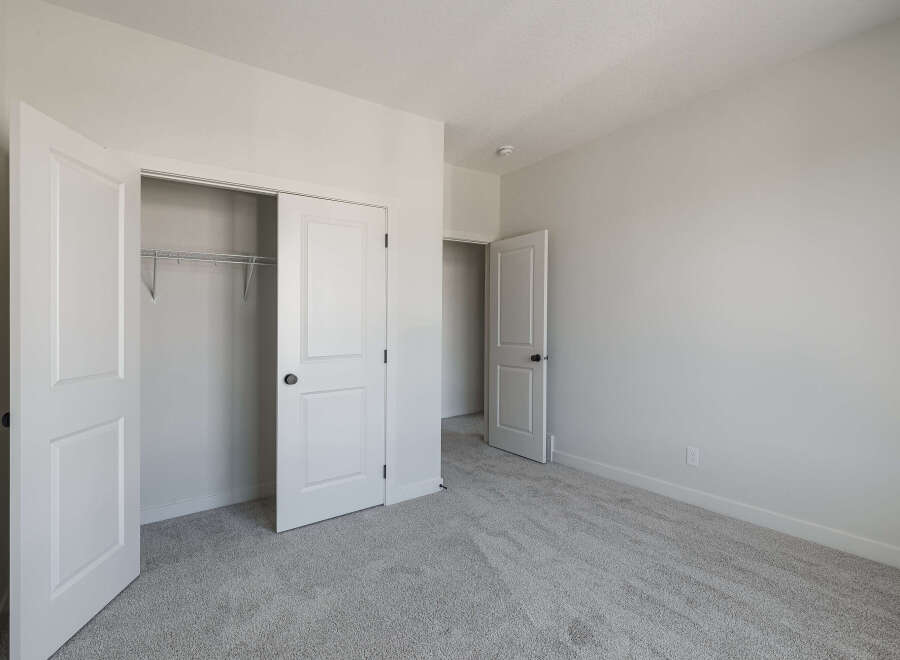 Step into this inviting bedroom, featuring a spacious closet with double doors and a convenient sliding door.