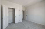 Step into this inviting bedroom, featuring a spacious closet with double doors and a convenient sliding door.