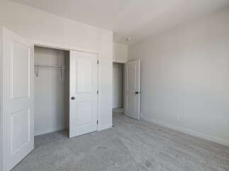 Step into this inviting bedroom, featuring a spacious closet with double doors and a convenient sliding door.