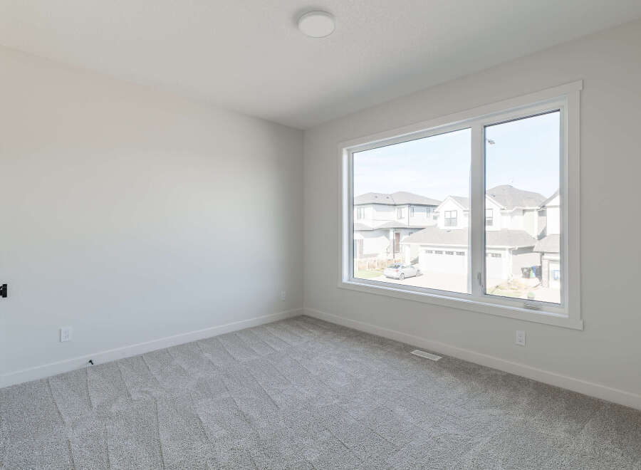 Step into this bright and airy room, featuring plush grey carpeting that adds warmth and comfort.