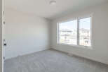 Step into this bright and airy room, featuring plush grey carpeting that adds warmth and comfort.